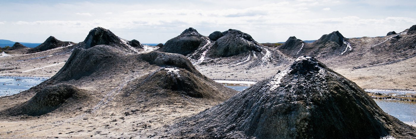 A natural geothermal phenomenon – active mud volcano with rising steam in Azerbaijan.
